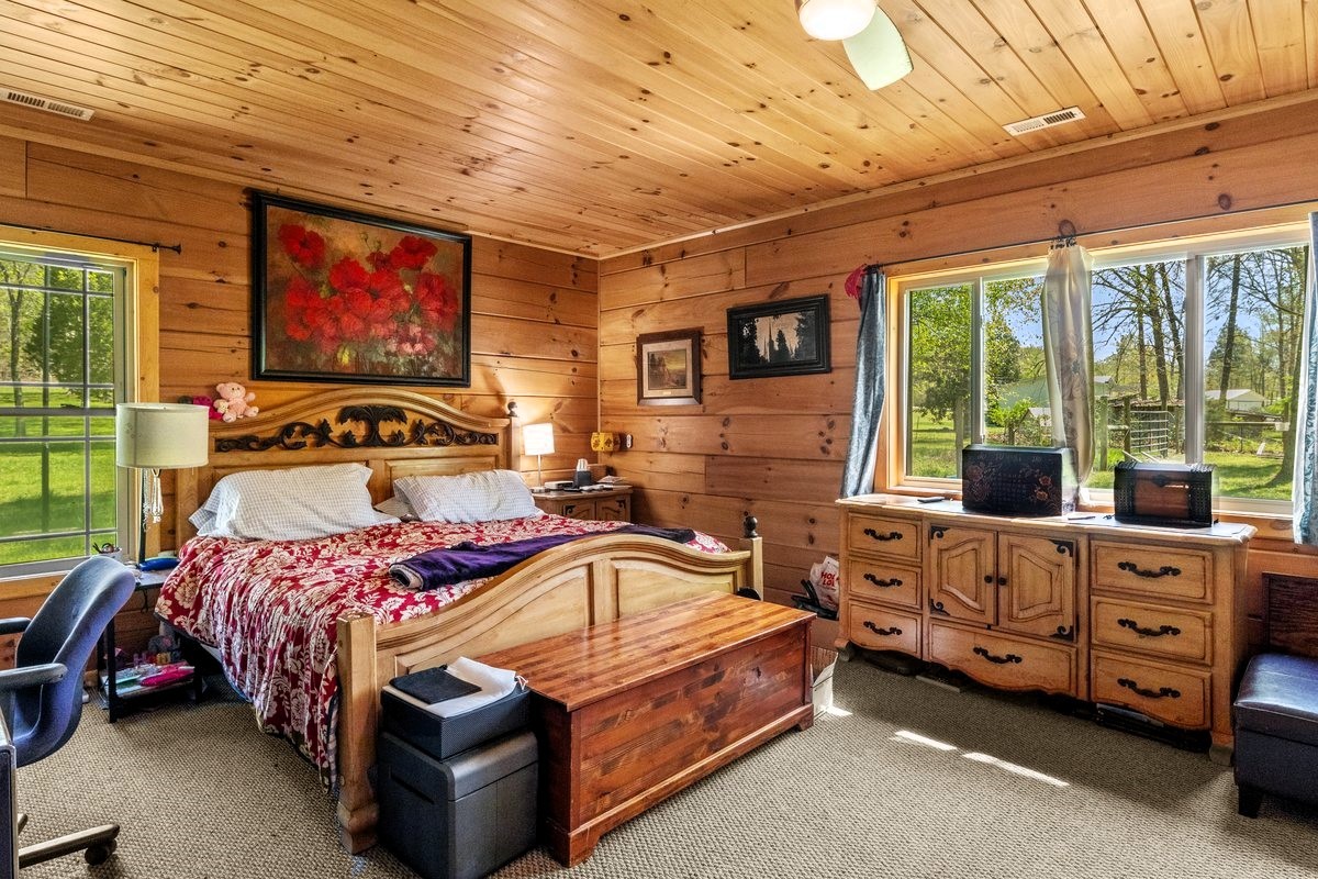 13631 Birdsong Road Holladay, TN 38341 - Photo 30 of 67 a bedroom with a bed and wooden floor