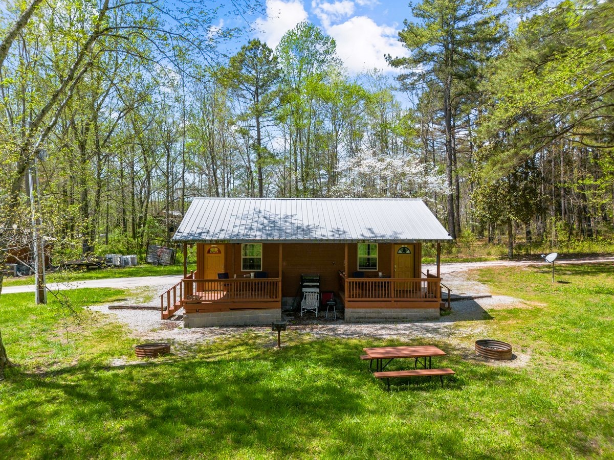 13631 Birdsong Road Holladay, TN 38341 - Photo 3 of 67 a view of a house with backyard and a tree