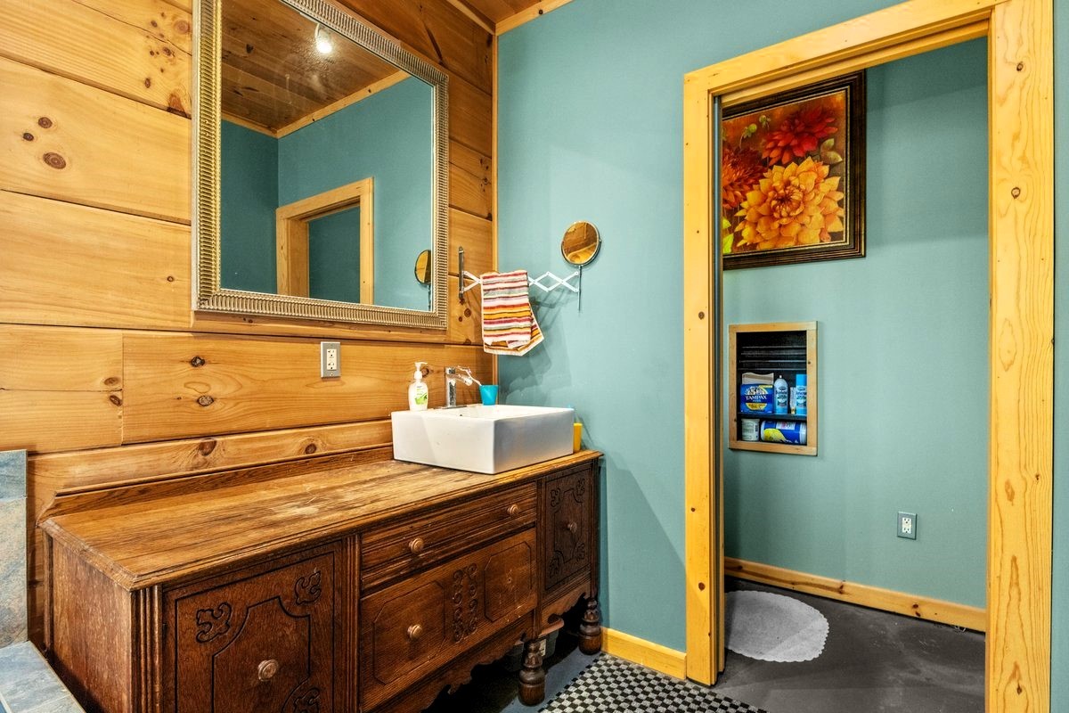 13631 Birdsong Road Holladay, TN 38341 - Photo 35 of 67 a bathroom with a sink and a mirror