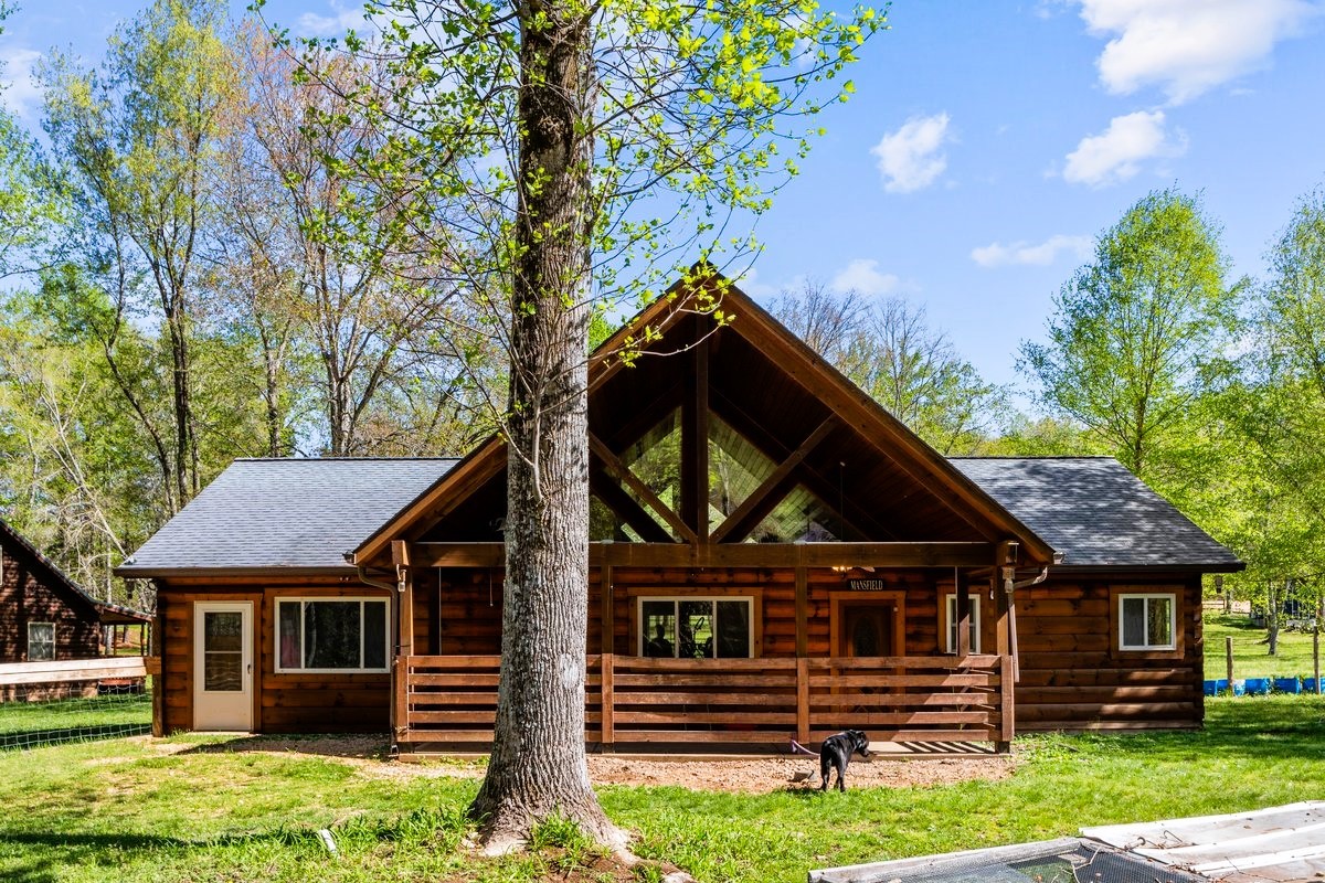13631 Birdsong Road Holladay, TN 38341 - Photo 7 of 67 front view of a house with a small yard