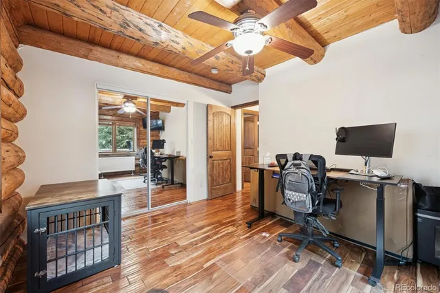 a view of a workspace with furniture and a window
