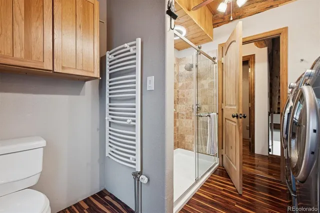 a bathroom with a toilet and a shower