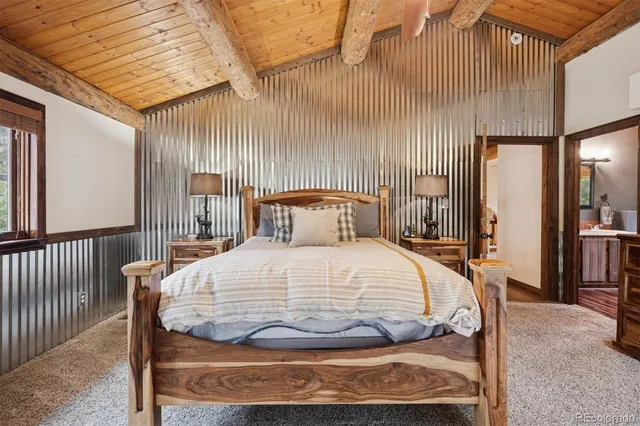 a room with a bed and large windows