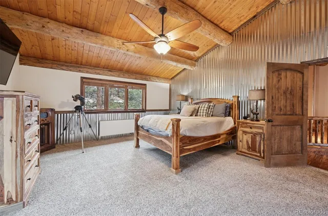 a bedroom with a bed lamp and a large window