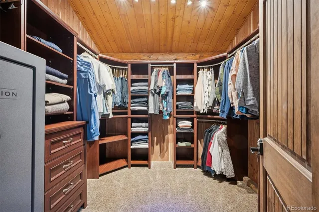 a view of walk in closet with clothes