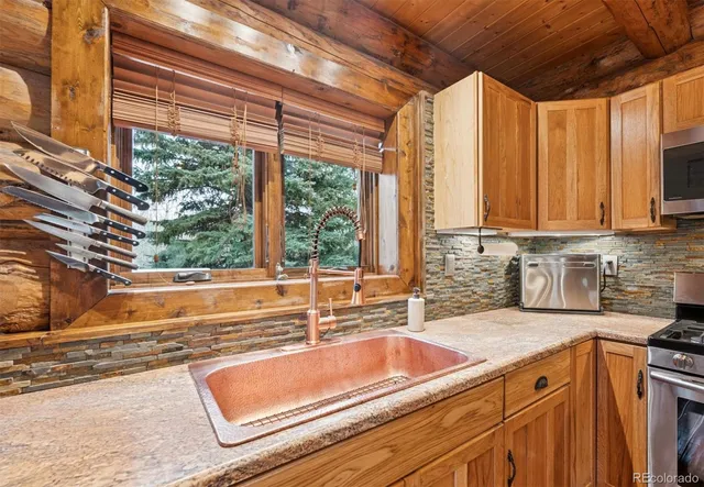 a kitchen with a sink and large window