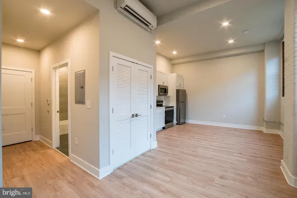a view of empty room with wooden floor