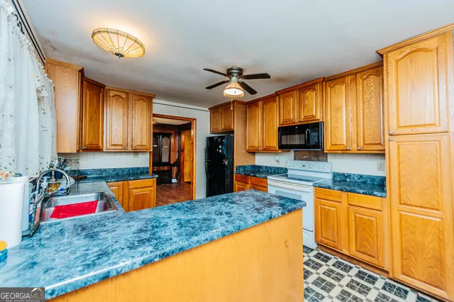 a kitchen with stainless steel appliances granite countertop a sink and a refrigerator