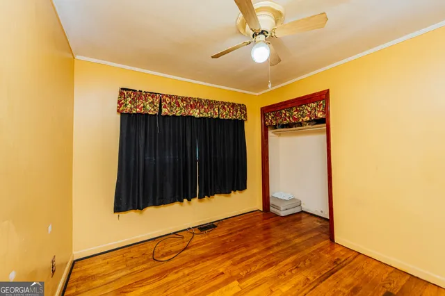 a view of a room with wooden floor