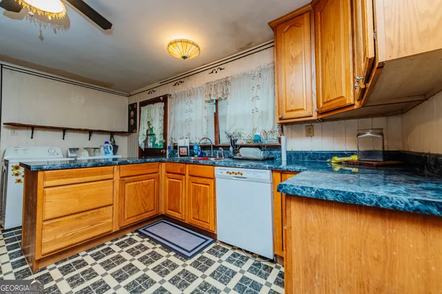 a kitchen with stainless steel appliances granite countertop a sink and cabinets