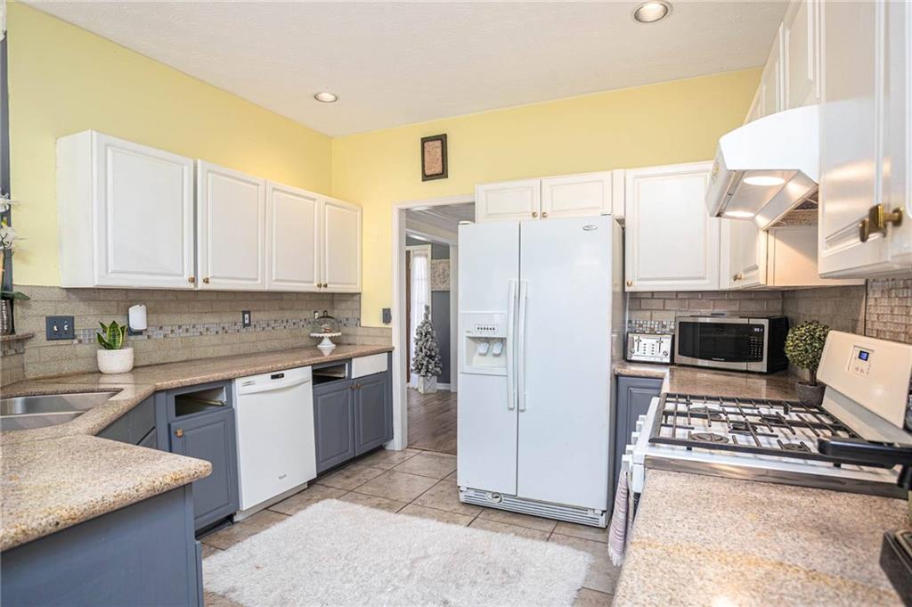 655 Scenic View Stone Mountain, GA 30087 - Photo 16 of 41 a kitchen with stainless steel appliances granite countertop a refrigerator a stove and a sink