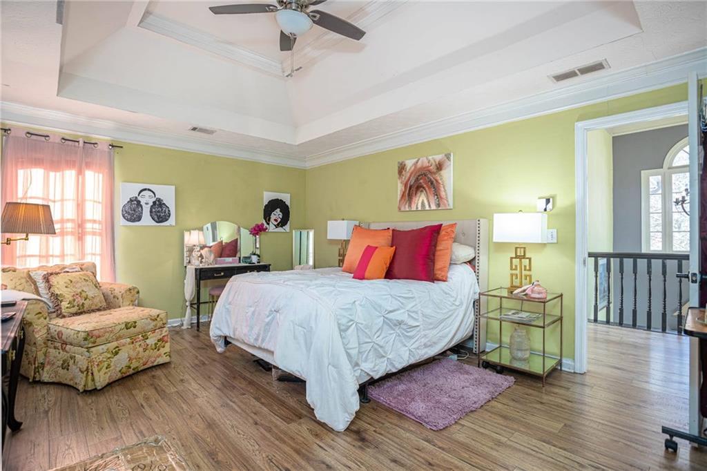 655 Scenic View Stone Mountain, GA 30087 - Photo 27 of 41 a bedroom with a bed and wooden floor