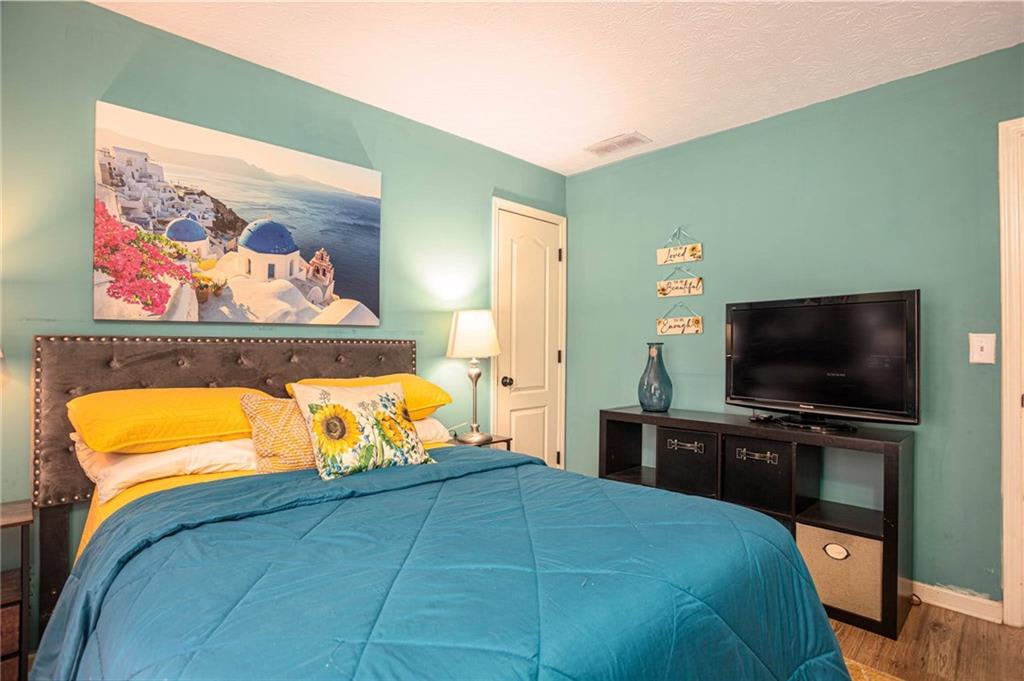 655 Scenic View Stone Mountain, GA 30087 - Photo 32 of 41 a bedroom with a bed and a flat screen television