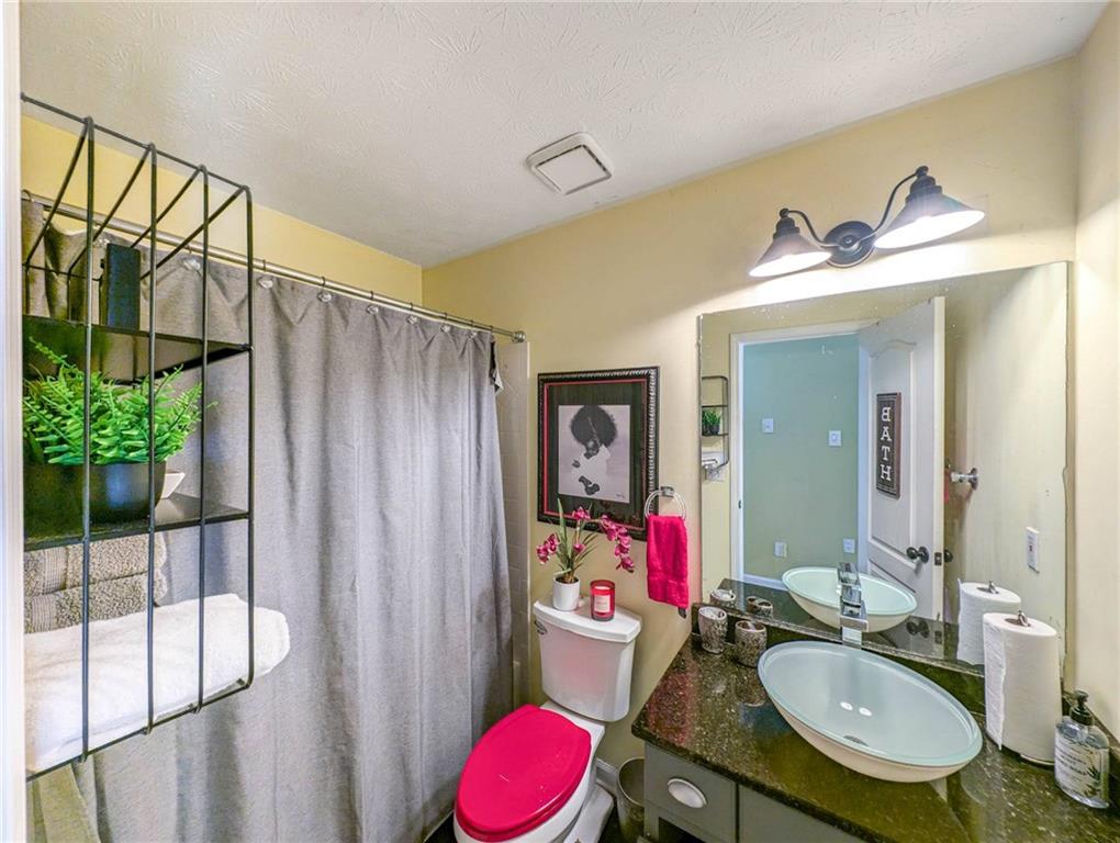 655 Scenic View Stone Mountain, GA 30087 - Photo 34 of 41 a bathroom with a granite countertop sink and a mirror