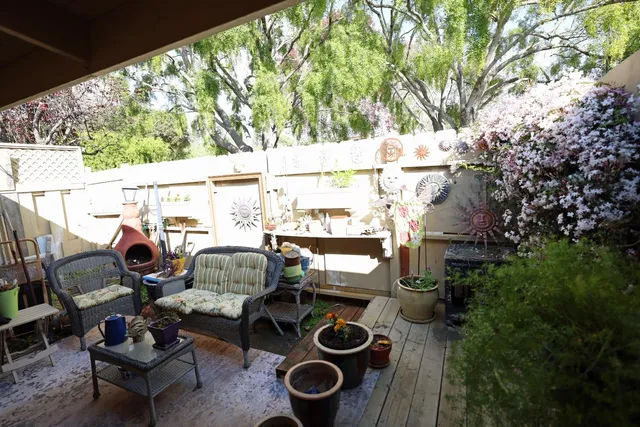 a view of a chairs and table in backyard