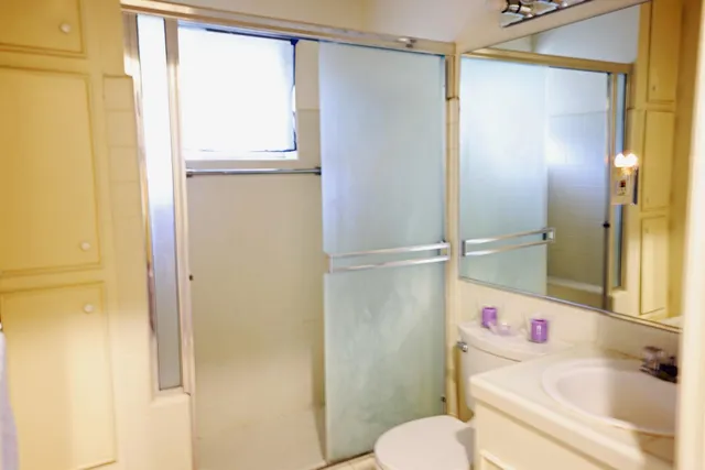 a bathroom with a sink toilet and shower