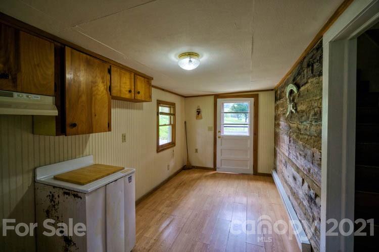 4900 Crabtree Mountain Road Clyde, NC 28721 - Photo 11 of 33 a view of a hallway to a livingroom with furniture wooden floor and windows