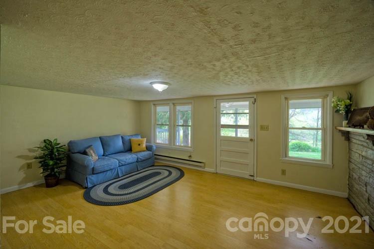 4900 Crabtree Mountain Road Clyde, NC 28721 - Photo 12 of 33 a living room with furniture window and wooden floor