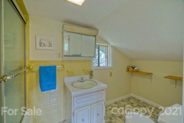 4900 Crabtree Mountain Road Clyde, NC 28721 - Photo 18 of 33 a bathroom with a sink and a mirror