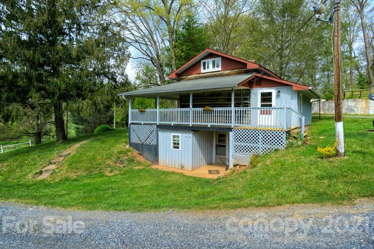 4900 Crabtree Mountain Road Clyde, NC 28721 - Photo 3 of 33 a front view of a house with a yard