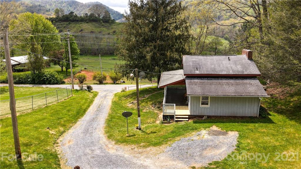 4900 Crabtree Mountain Road Clyde, NC 28721 - Photo 28 of 33 a aerial view of a house with swimming pool garden and patio