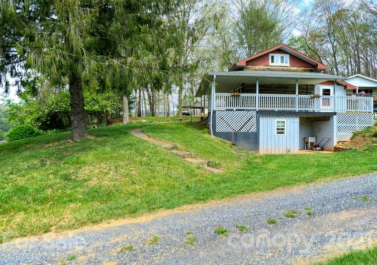 4900 Crabtree Mountain Road Clyde, NC 28721 - Photo 4 of 33 a front view of a house with a yard