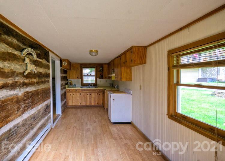 4900 Crabtree Mountain Road Clyde, NC 28721 - Photo 9 of 33 a view of kitchen with window and wooden floor
