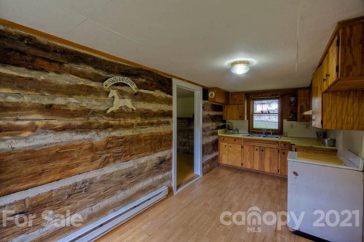 4900 Crabtree Mountain Road Clyde, NC 28721 - Photo 10 of 33 a kitchen with stainless steel appliances granite countertop a refrigerator and a stove top oven
