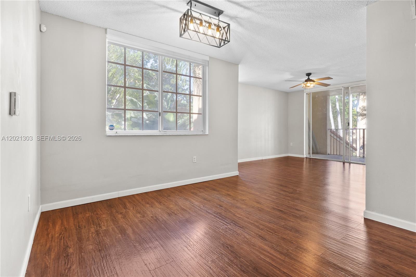 2123 Renaissance Boulevard, Unit 201 Miramar, FL 33025 - Photo 9 of 22 wooden floor in an empty room with a window