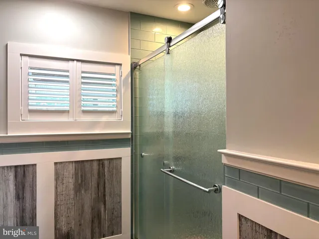 a bathroom with a shower and a window
