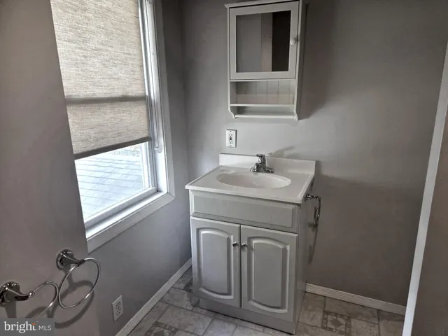 a bathroom with a shower curtain and a curtain