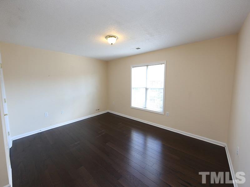 11370 Involute Place, Unit 105 Raleigh, NC 27617 - Photo 10 of 15 an empty room with wooden floor and windows