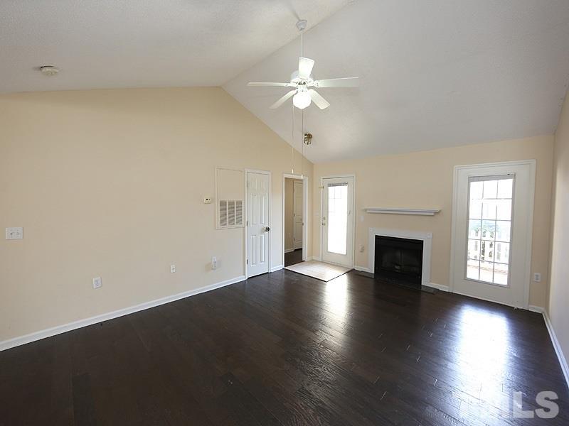 11370 Involute Place, Unit 105 Raleigh, NC 27617 - Photo 15 of 15 an empty room with wooden floor chandelier fan and windows