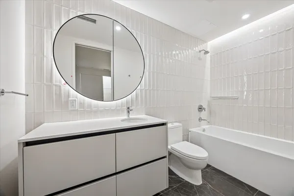 a bathroom with a toilet a sink and a mirror