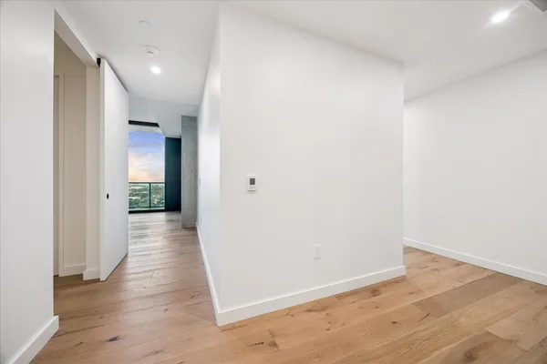 a view of a hallway with wooden floor