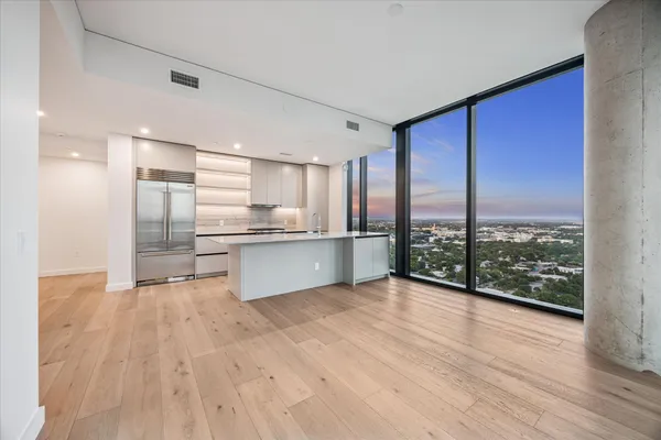 a view of kitchen with kitchen island wooden floor and window