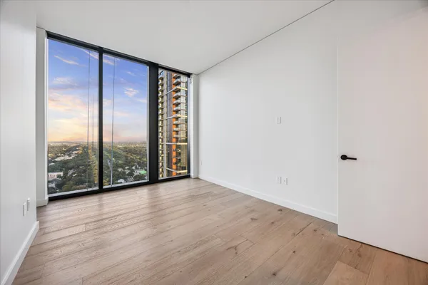 wooden floor in an empty room with windows
