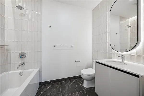 a bathroom with a sink toilet tub and shower