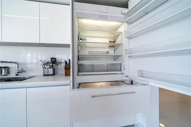 a kitchen with a refrigerator and cabinets