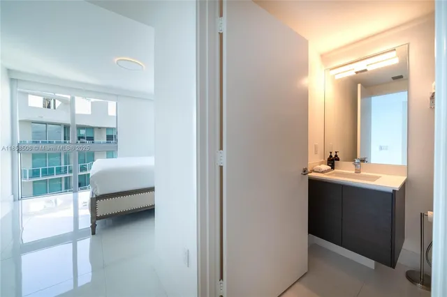 a en suite bathroom with a sink and mirror