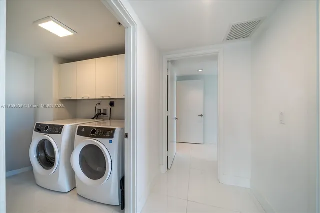 a utility room with sink dryer and washer