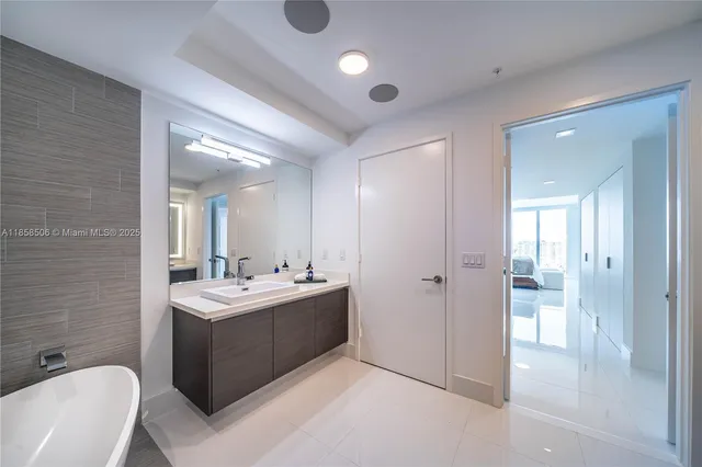 a bathroom with a double vanity sink toilet and shower