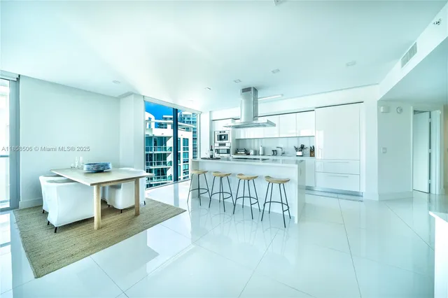 a kitchen with a table and chairs