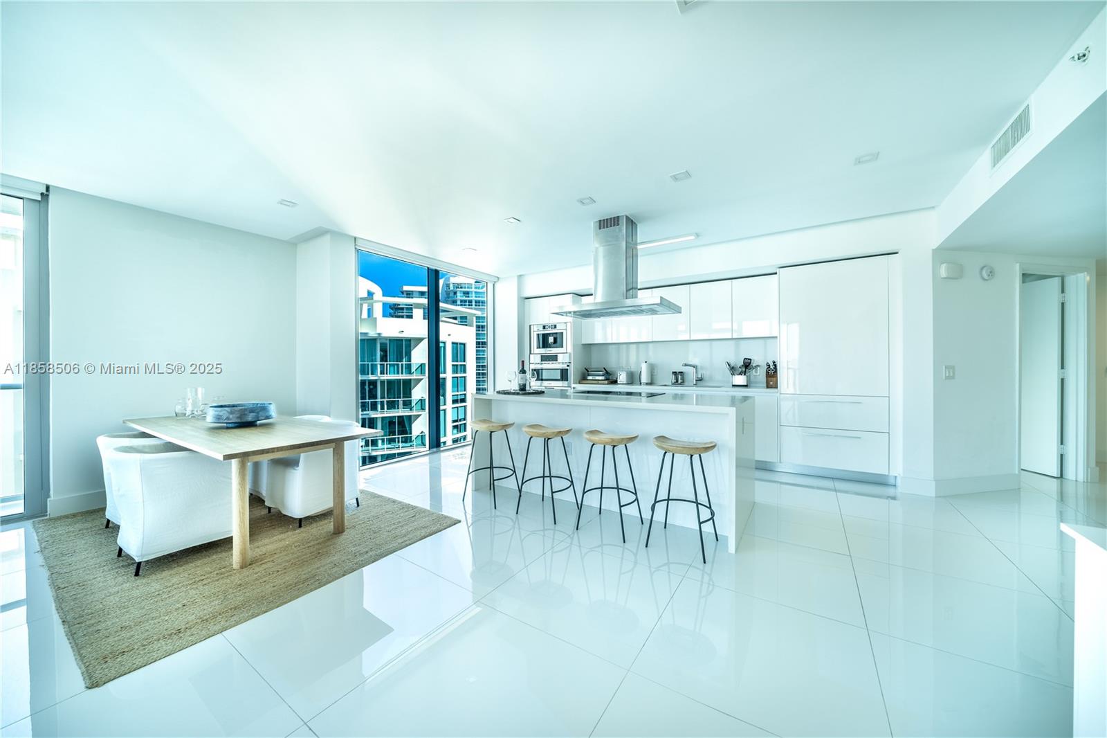 300 Sunny Isles Boulevard, Unit 41901 Sunny Isles Beach, FL 33160 - Photo 5 of 28 a kitchen with a table and chairs