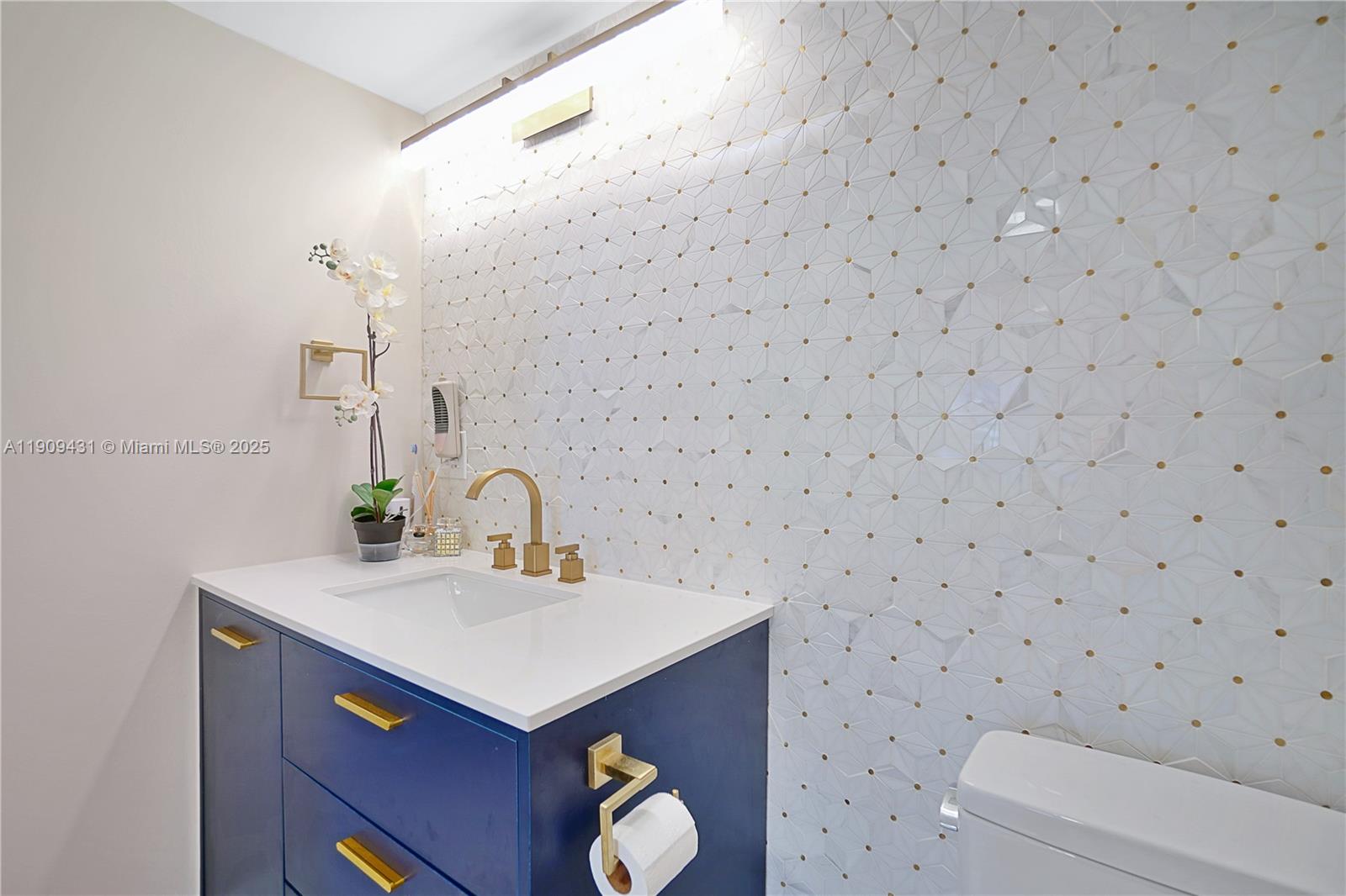 5225 Collins Avenue, Unit 1403 Miami Beach, FL 33140 - Photo 13 of 21 a bathroom with a sink a toilet and mirror