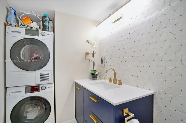 a bathroom with a sink a washer and dryer