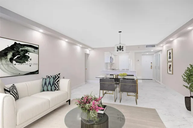 a living room with furniture and a chandelier