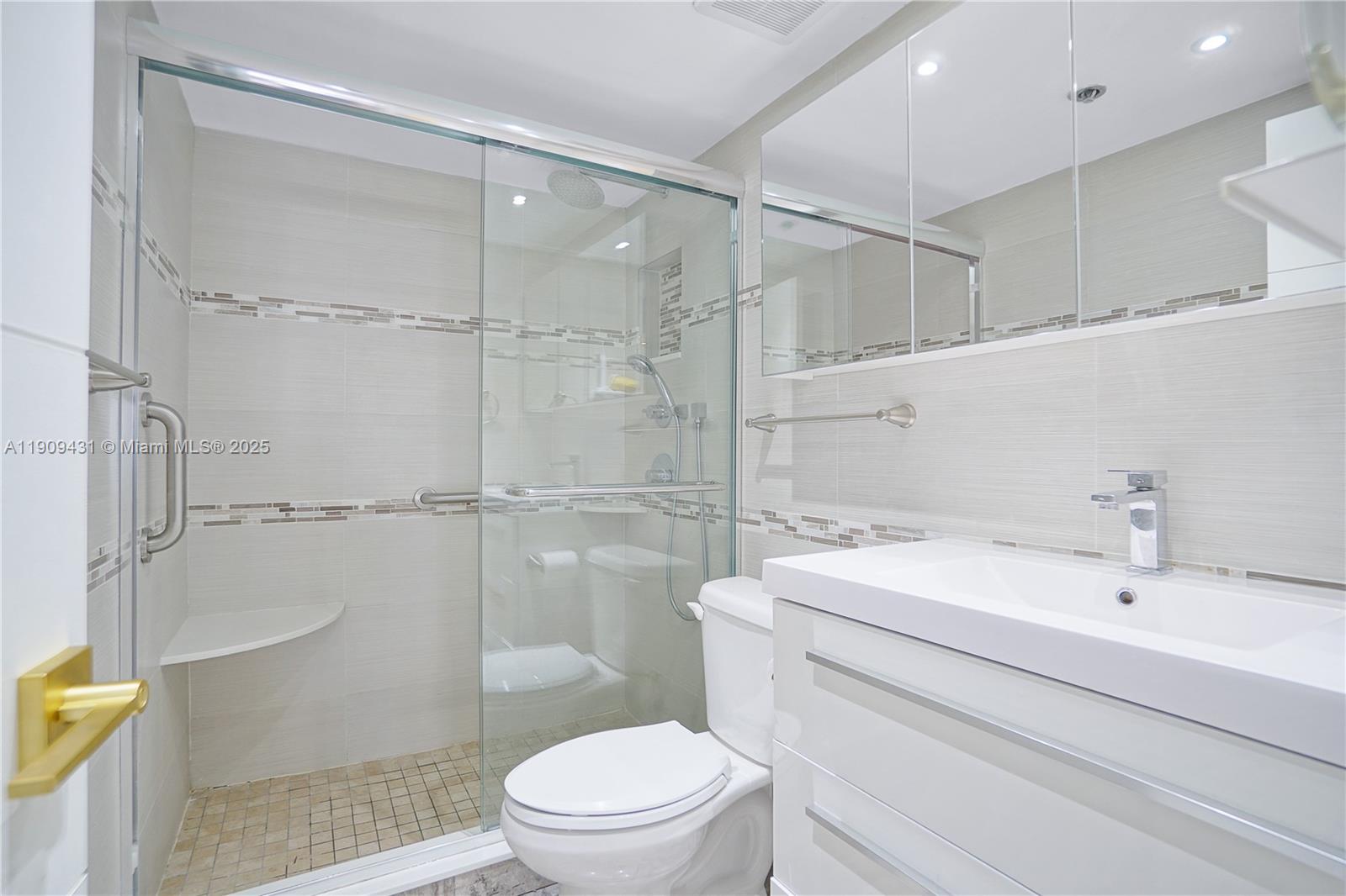 5225 Collins Avenue, Unit 1403 Miami Beach, FL 33140 - Photo 8 of 21 a bathroom with a sink a toilet and shower