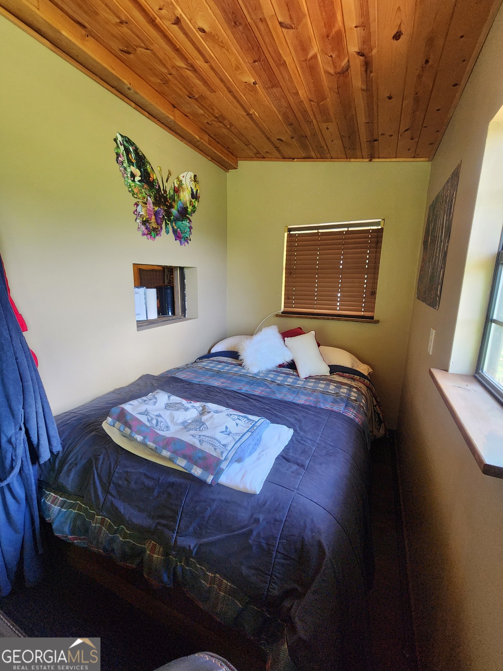 568 Yonah Lake Road Toccoa, GA 30577 - Photo 14 of 21 a bedroom with a bed and a wall painting