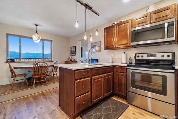 a kitchen with stainless steel appliances granite countertop a stove microwave and sink